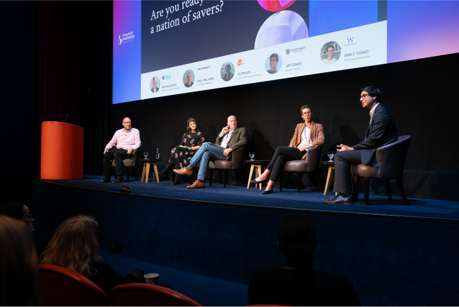 Panel discussion at a Financial Wellbeing conference featuring several speakers discussing saving strategies.
