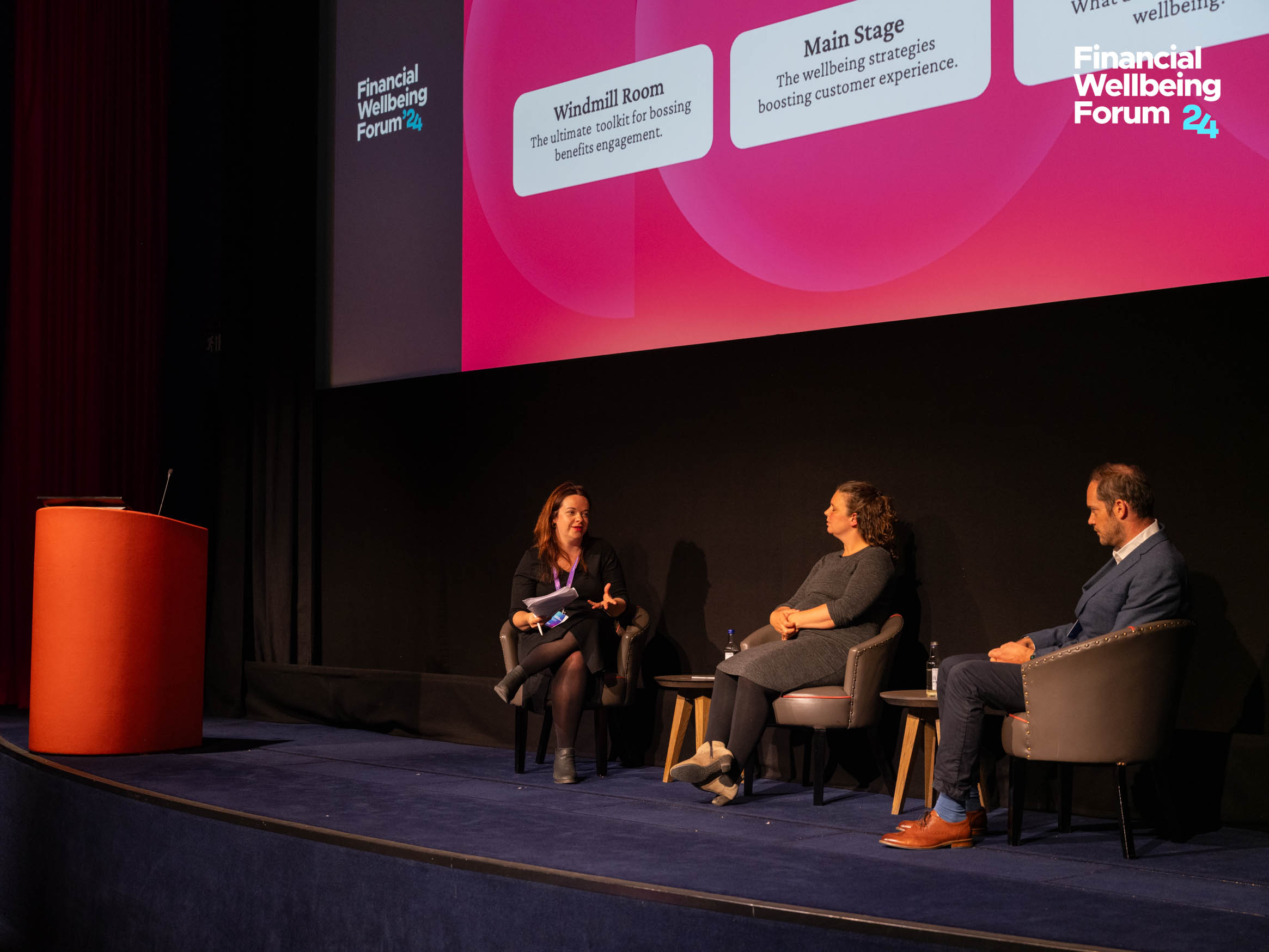 Panel discussion at the Financial Wellbeing Forum 24, featuring three speakers sharing insights on wellbeing strategies and boosting customer experience.
