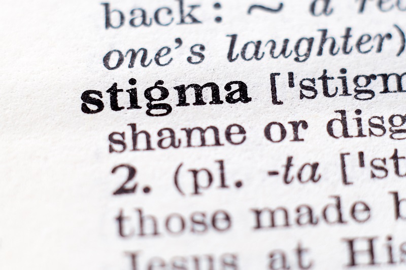 Close-up of a dictionary page showing the definition of the word "stigma."
